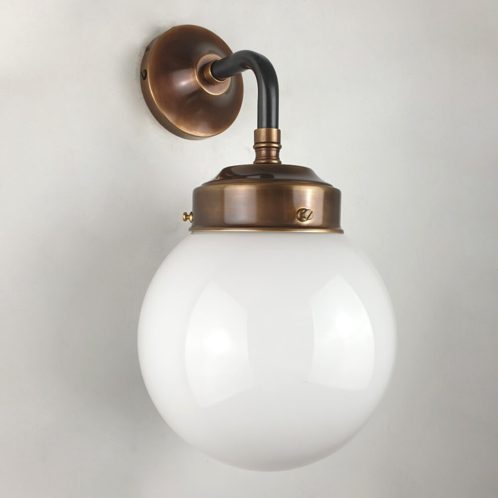two tone black and brass wall light with opal globe