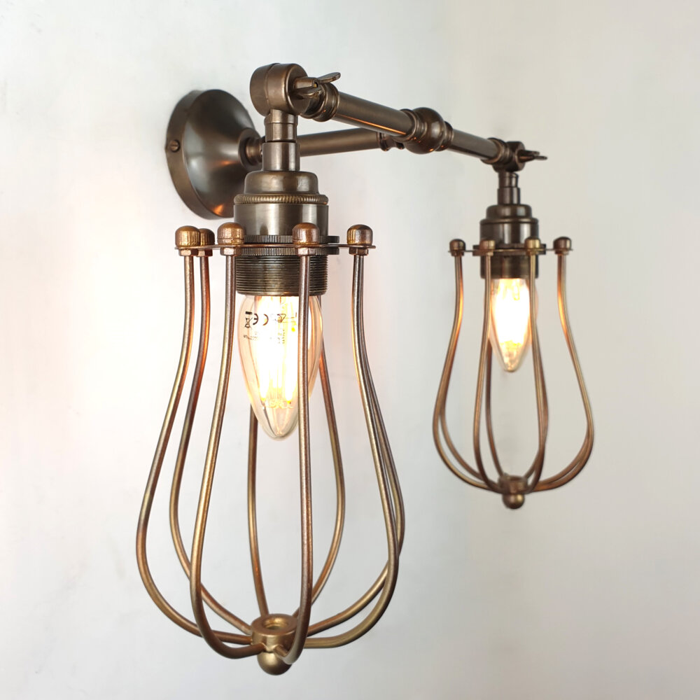 double arm brass wall light with brass cage shades