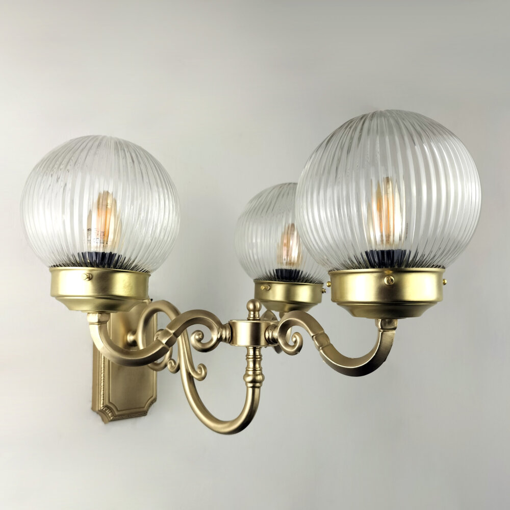 three arm wall light with prismatic glass globe